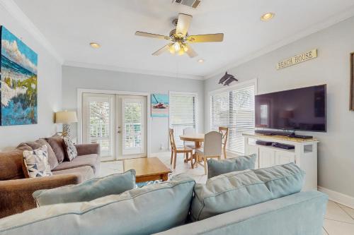 a living room with a couch and a flat screen tv at Molokai Villas 5B in Pensacola