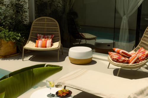 a table with two chairs and a table with a plate of food at Palazzo Console in Lecce
