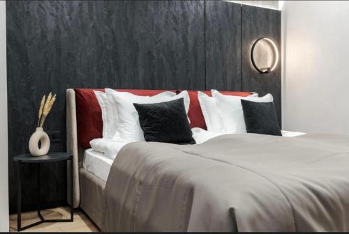 a bedroom with a large bed with red and white pillows at Преміальні апартаменти на березі озера Молодості in Bukovel