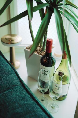 two bottles of wine and two glasses on a table at Home Story in Tokyo Kanametyo-Ikebukuro-Ginzaまで直通&東京屋語 in Tokyo