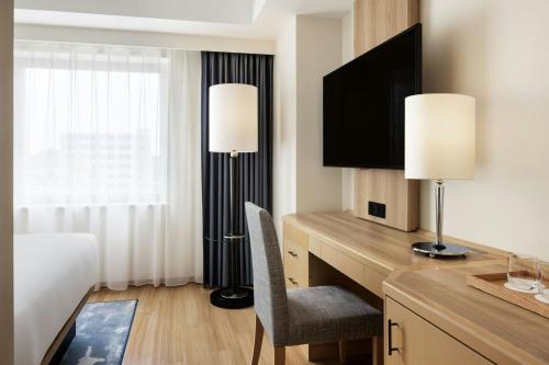 a hotel room with a desk with a television at Fairfield by Marriott Sapporo in Sapporo
