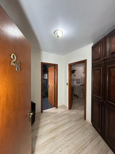 an empty hallway with a door and a room at Casa do Rogerio Hostel - Unidade Shopping in Caxias do Sul