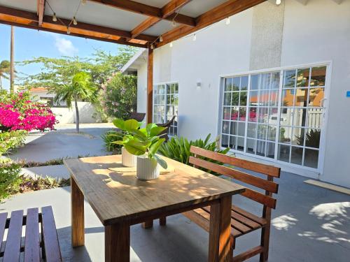 a wooden table and two benches on a patio at Bubali Residence in Palm-Eagle Beach