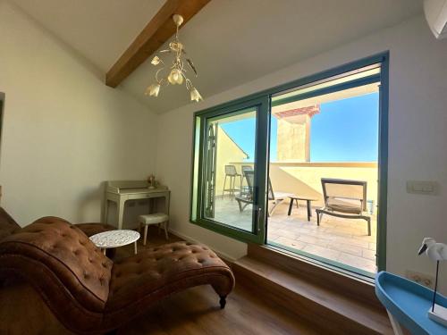 a living room with a couch and a large window at Casa Valentina in Piran