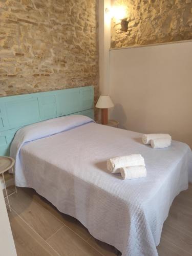 a bedroom with a bed with towels on it at Maktub Medina in Medina Sidonia