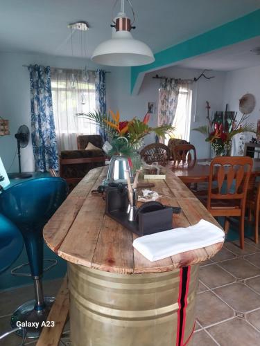 a table made out of a barrel with a machine on it at Angel's Appt in Rivière Noire