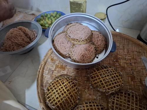 a table with three bowls of food on a table at Juno Homestay in Mulatiyana