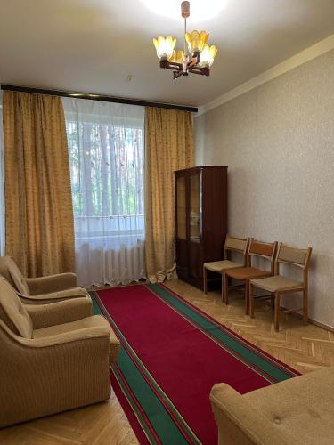 a living room with a couch and chairs and a rug at GREENMIST apartaments in Kyiv