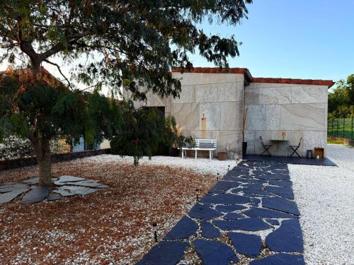 a stone building with a bench in front of it at Casa Miñortos in Miñortos