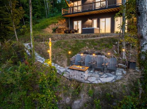 a house with a table and chairs in front of it at Jolene Lookout in Dandridge