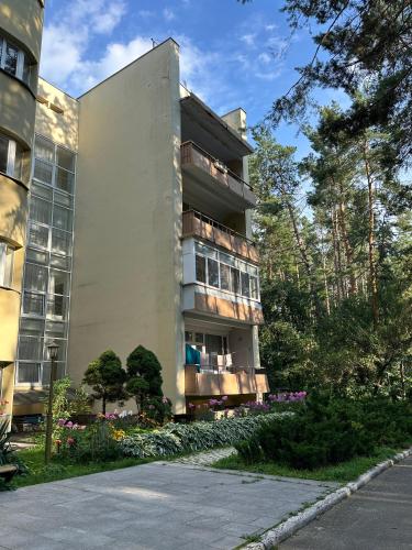 a tall building with flowers in front of it at GREENMIST apartaments in Kyiv