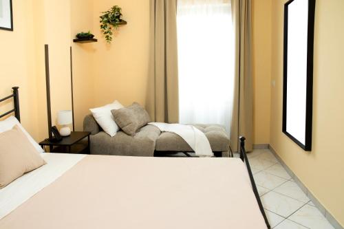 a living room with a bed and a couch at Lovely Fiuggi Apartment - near the Thermal Baths in Fiuggi