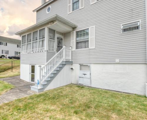 a white house with a staircase on it at 1-Bedroom, 1-Bath Getaway in Carbondale
