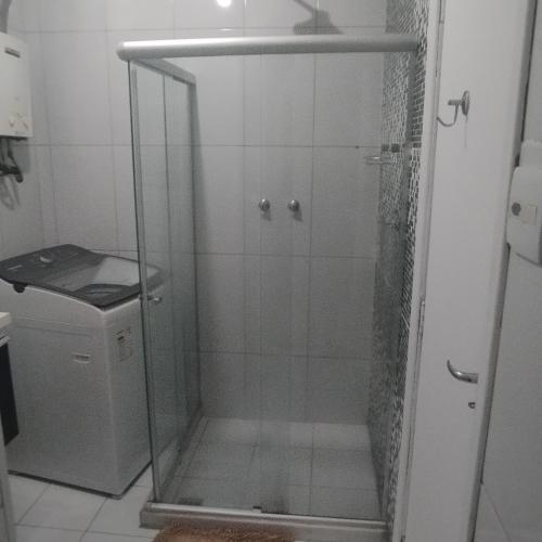 a shower with a glass door in a bathroom at Cobertura posto 5 in Rio de Janeiro
