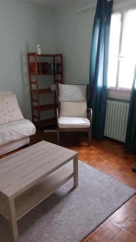 a living room with a couch and a chair at chambre dans villa in Marseille