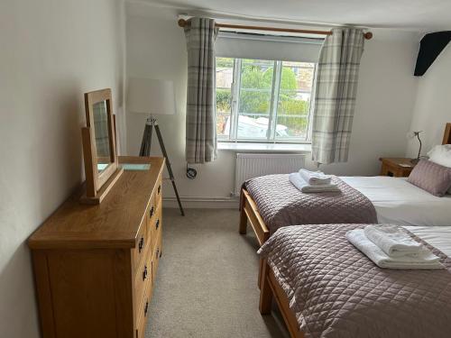 En eller flere senge i et værelse på Bramble Cottage