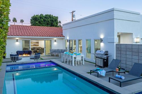 a villa with a swimming pool and a house at Royal Escape by ACME House Company in Palm Springs