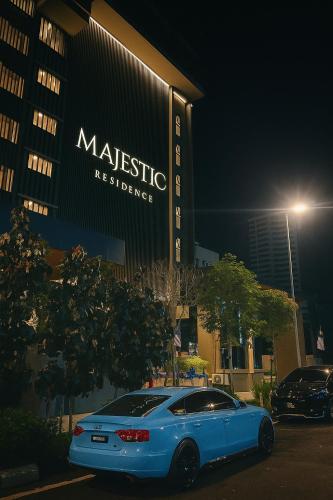 a blue car parked in front of a building at Premier Suites KLCC By Majestic Residence in Kuala Lumpur