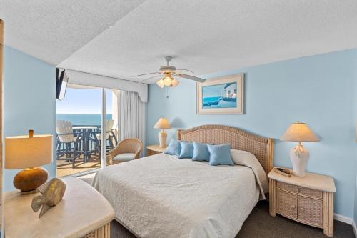 a bedroom with a bed with a view of the ocean at Ashworth 1709 in North Myrtle Beach