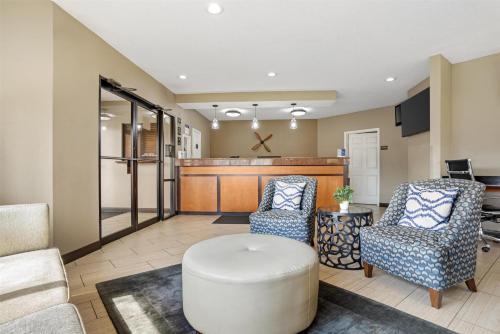 a living room with two chairs and a table at Best Western Airport Inn in Pearl