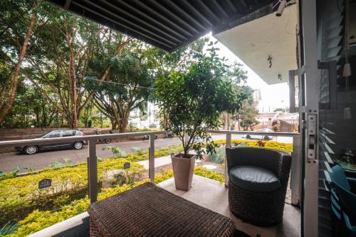 a balcony with a table and a chair and a tree at VIP planet urban Room in Armenia