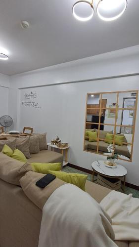 a living room with two couches and a table at Mysuites2go 517 Lenden in Manila