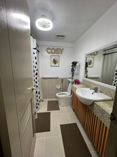 a bathroom with a toilet and a sink at Mysuites2go 517 Lenden in Manila