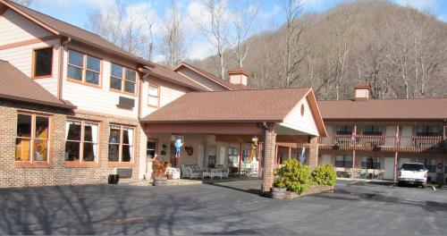 Un edificio con un estacionamiento enfrente. en Jonathan Creek Inn and Villas, en Maggie Valley