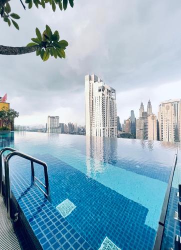 a swimming pool on top of a city skyline at Premier Suites KLCC By Majestic Residence in Kuala Lumpur