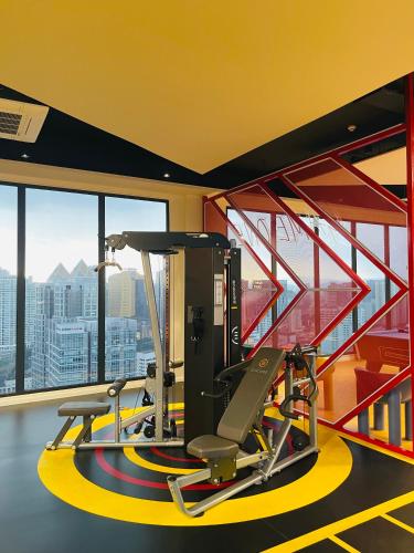 a gym with a treadmill and a view of the city at Premier Suites KLCC By Majestic Residence in Kuala Lumpur