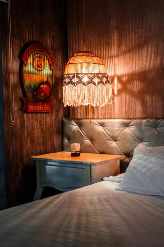 a bedroom with a bed and a table with a lamp at VIP planet urban Room in Armenia