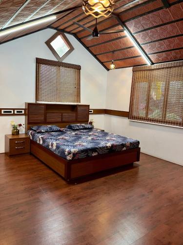 a bedroom with a large bed in a room at Wood House Near Isha And Karunya University by Shivalaya in Alāndurai