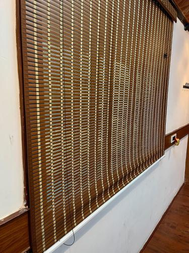 a window with bamboo blinds in a room at Wood House Near Isha And Karunya University by Shivalaya in Alāndurai