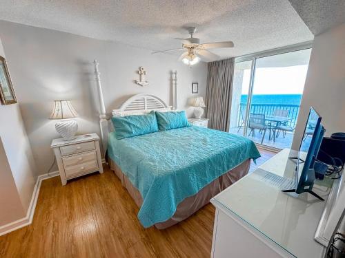 a bedroom with a bed and a desk with a computer at Ashworth 903 in North Myrtle Beach