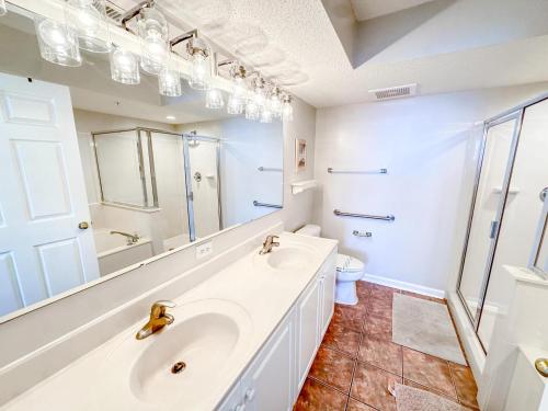 a white bathroom with a sink and a toilet at Ashworth 903 in North Myrtle Beach