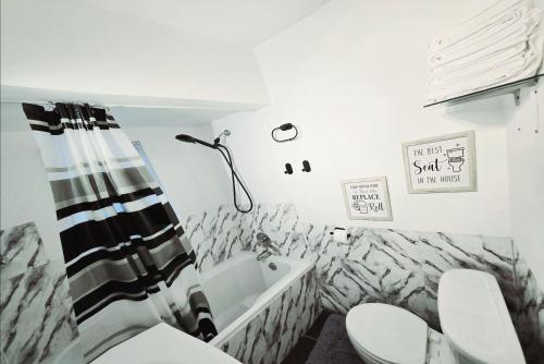 a bathroom with a toilet and a sink at Private Airconditioned 2 Bedroom Home Private Parking in Burnaby