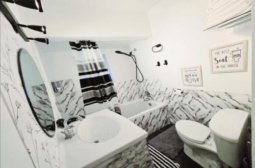 a white bathroom with a sink and a toilet at Private Airconditioned 2 Bedroom Home Private Parking in Burnaby