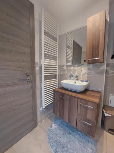 a bathroom with a sink and a mirror and a shower at Maison du bois in Torgnon