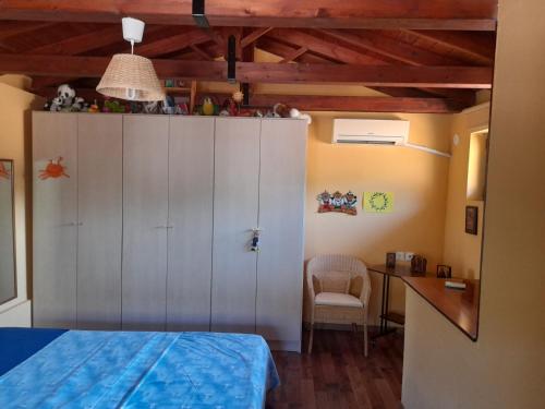 a bedroom with a white cabinet and a desk at MOMENTS of HAPPINESS in Soúrpi