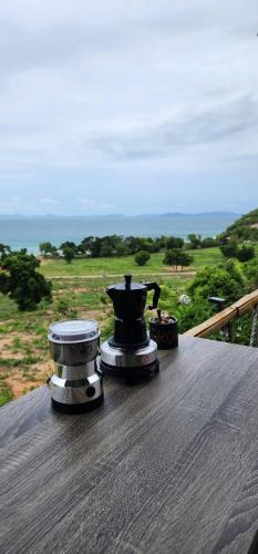 a tea kettle on top of a table on a deck at Duview room in Nong Prue