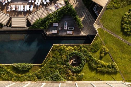 an overhead view of a swimming pool with plants at The Ritz-Carlton O'ahu, Turtle Bay in Kahuku