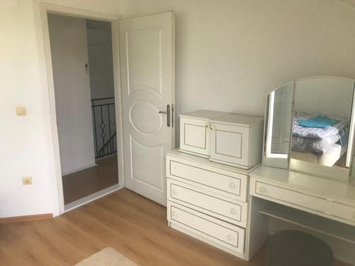 a room with a white dresser with a mirror and a mirror at Holiday & Living House Near Sarajevo in Vogošća