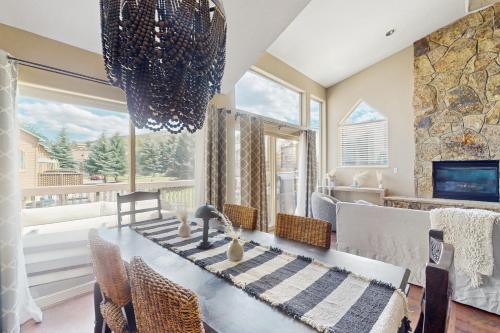 a dining room with a table and a large window at Beaver Creek Bungalow in Edwards