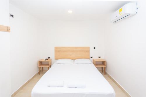 Postel nebo postele na pokoji v ubytování Hotel Villa Real 70 Laureles