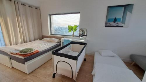 a small bedroom with a bed and a window at Lake Beach Villa Mazury in Kałduny