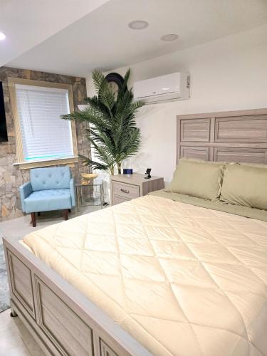 a bedroom with a large bed and a blue chair at Vessel Hotel Studio Suites of Atlanta, GA in Atlanta