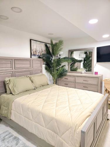 a bedroom with a large bed and a large mirror at Vessel Hotel Studio Suites of Atlanta, GA in Atlanta