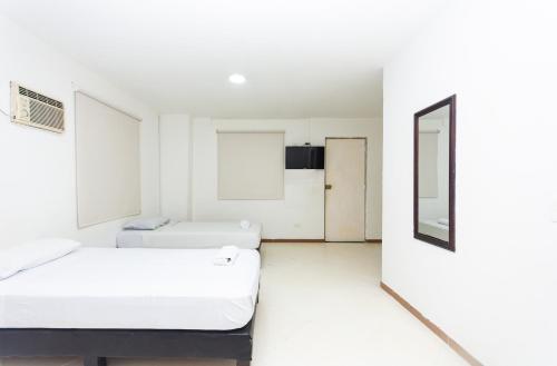 Postel nebo postele na pokoji v ubytování Hotel Villa Real 70 Laureles