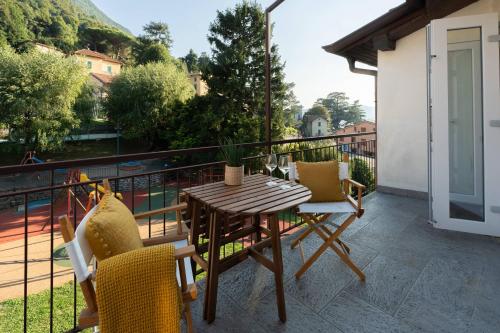 a patio with a table and chairs on a balcony at Terrace Over Torno - by MyHomeInComo in Torno