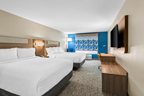 a hotel room with two beds and a flat screen tv at Holiday Inn Express and Suites Hotel - Pauls Valley by IHG in Pauls Valley